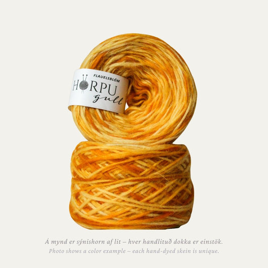 Hand-dyed Icelandic lopi yarn in warm yellow and orange tones inspired by marigold flowers