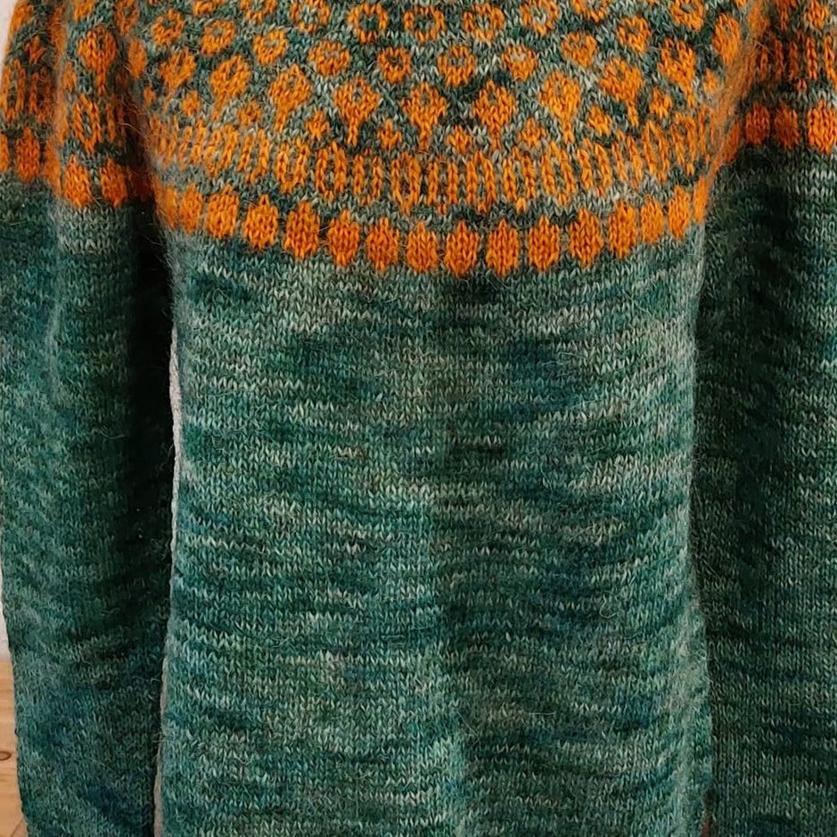 Knitted Icelandic sweater made with hand-dyed Þingborg lopi inspired by lily of the valley in deep green tones with orange pattern
